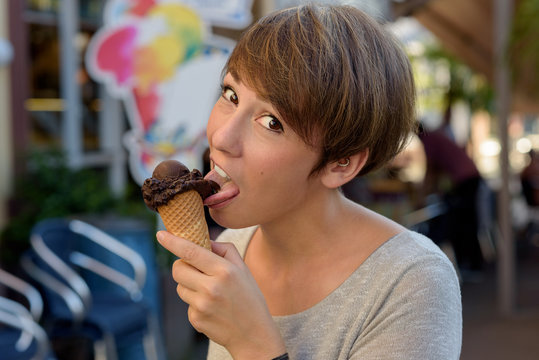 Young Woman Eating A Chocolate Ice Cream Cone