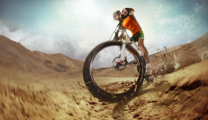 Fototapeta na wymiar Sport. Mountain Bike cyclist riding single track in desert 