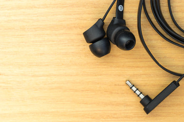 earphone on wood desktop
