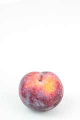 Closeup of ripe plum isolated on white.