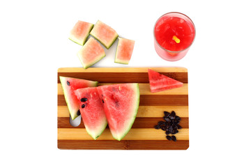 sliced watermelon and juice on a white background