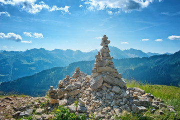 Rock Cairns Overlooking Alpine Mountain Range