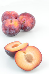 Closeup of ripe plums isolated on white.