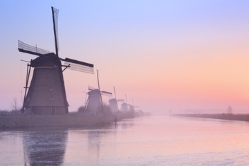 Dutch windmills at sunrise in winter at the Kinderdijk