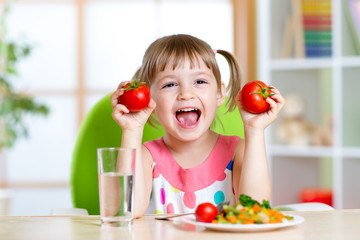 Portrait of happy child with vegetables