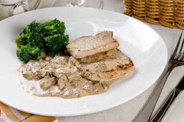 medallions of pork stewed with mushrooms in a creamy garlic sauc