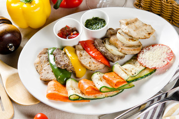 slices of beef, pork and chicken grilled with vegetables grilled