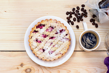 Homemade pie with coffee on a wooden background