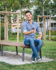 Obraz premium Young handsome man posing in a city park