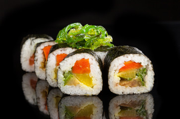 Maki sushi served on black background