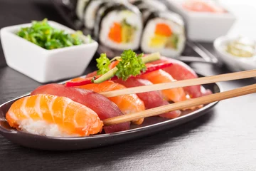 Foto op Plexiglas sushi pieces with chopsticks © Jag_cz