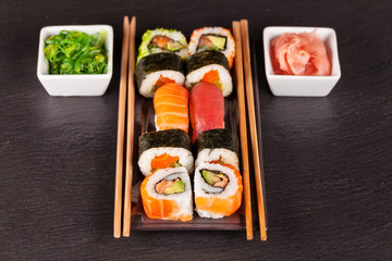 sushi pieces with chopsticks