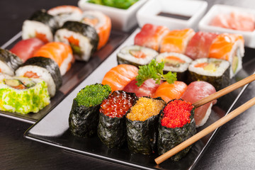 sushi pieces with chopsticks