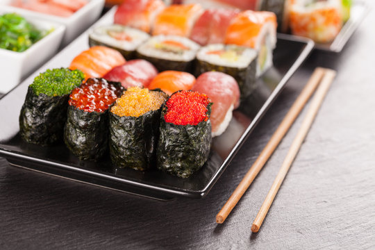sushi pieces with chopsticks