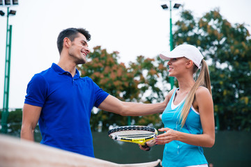 Tennis players talking at the court