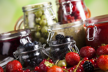 Set of glass jars with fruits jam 
