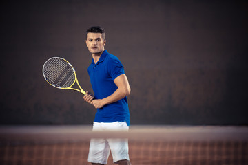 Handsome man playing in tennis