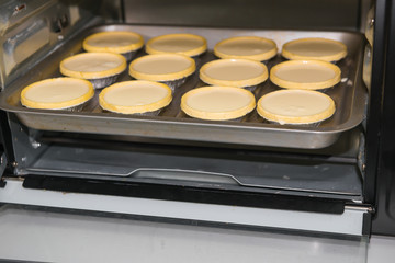 egg tarts about to be cooked in the oven