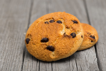 Close up of stacked chocolate chip cookies on grey wooden background