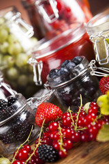 Set of glass jars with fruits jam 