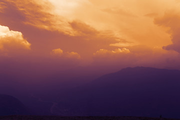 Majestic sunset in the mountains landscape with clouds. 