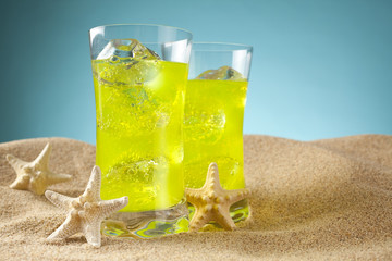 Cold drinks on the beach and blue background