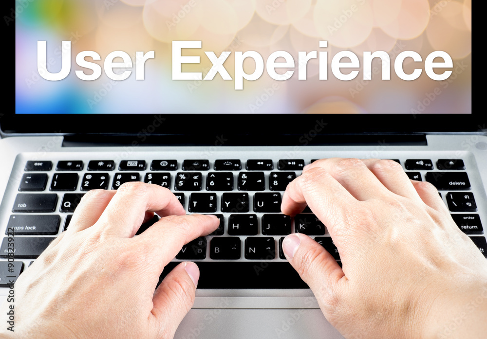 Poster User experience word on laptop screen with hand type on keyboard