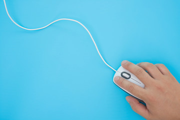 man using a white mouse on a blue background