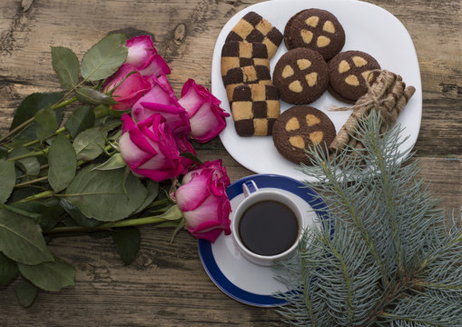 bouquet of beautiful roses, coniferous branch, cookies and coffe