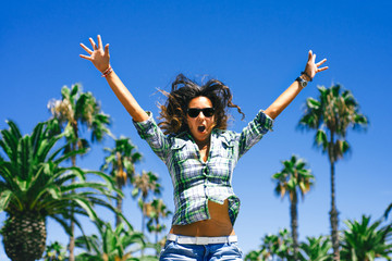 Beautiful funny smiling girl is jumping in palm trees in sunny Barcelona in summer
- 90826198