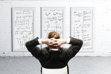 businessman looking formulas on desk