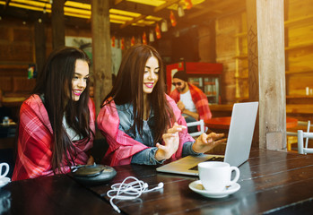 two girls watching something in laptop