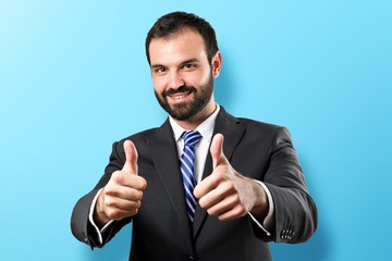 Young businessman getting OK over white background