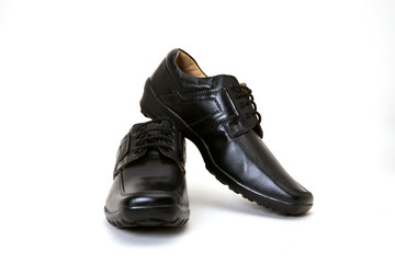 a pair of black leather shoes for men isolated on white available with clipping path
