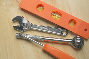 work tools orange colour on wood., screwdriver, wrench, level, etc.