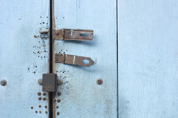 Rusty bolt on blue wooden door