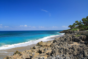 Ocean with waves and rocks on caribbean beach