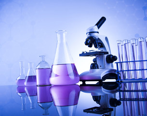 Laboratory work place with microscope and glassware