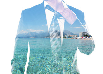 Double exposure portrait of businessman and clear blue sea. Concept of tired manager dreaming to escape from work and relax on peaceful beach. 