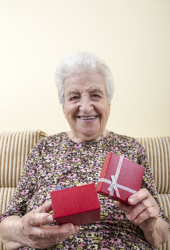 Happy Senior Woman Opening Gift