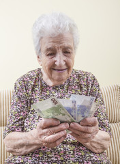 senior woman counting euros