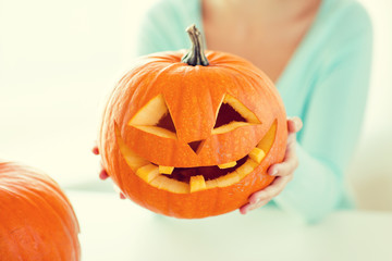 close up of woman with pumpkins at home