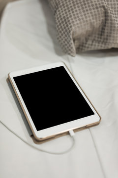 Digital tablet PC in bed.