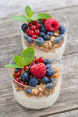dessert with milk cream, muesli and berries, top view
