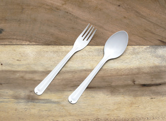 spoon and fork on wooden background