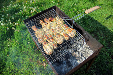 Barbecue with chicken  in metal grate