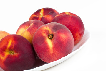 Peaches on white plate