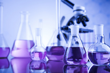 Laboratory work place with microscope and glassware