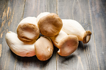 Fresh King Oyster mushroom (Eringi) on wooden background,food ingredient