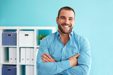 Young businessman with crossed arms